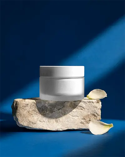 Elegant Cosmetic Jar Mockup On Natural Stone Display With Petal Accents For Premium Branding