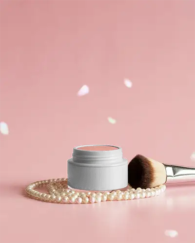 compact-blush-jar-cosmetic-mockup-on-pink-surface-with-pearl-necklace-petals-and-brush-in-soft-glow