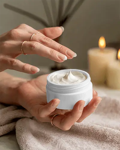 hand-held-jar-cosmetic-mockup-on-towel-with-candlelight-soft-focus-spa-inspired-cozy-wellness-scene