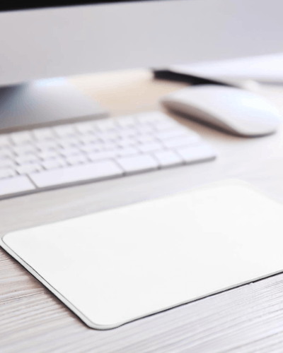 small-gaming-pad-on-a-laminated-table-with-imac-and-magic-mouse