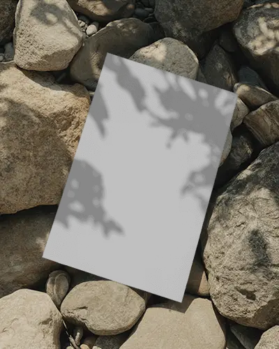 Vertical Poster Mockup Placed On Rocky Surface With Natural Light Shadow Effect