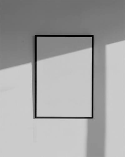 Modern Interior Frame Poster Mockup On Plain Wall With Wooden Table And Decor