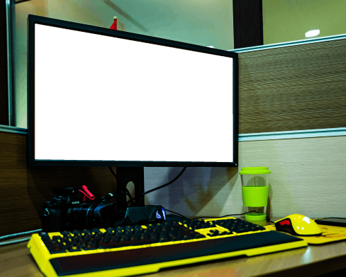Desktop Monitor Mockup With Vibrant Keyboard And Accessories In Office Cubicle