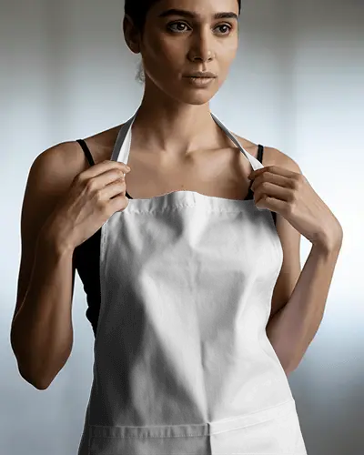 Close Up Apron Mockup With Model Adjusting Straps Studio Shot Focused On Fit And Fabric Draping
