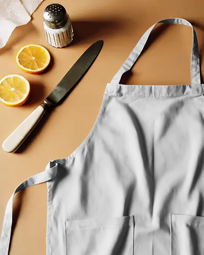 apron-mockup-with-kitchen-accessories-knife-lemon-and-salt-container-flat-lay-warm-toned-background