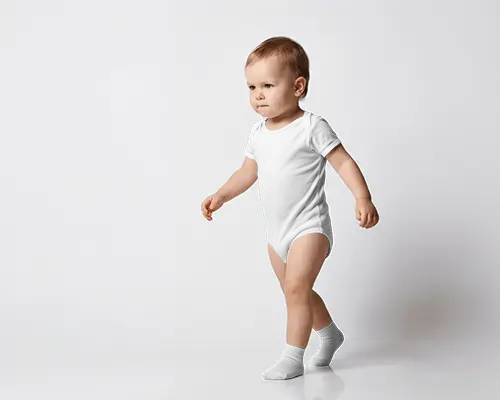 Walking Toddler Baby Onesie Mockup Side Angle Motion Pose Clean Studio Floor With Soft Shadow