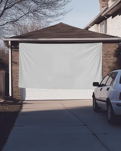 Suburban Driveway Banner Mockup Horizontal Fabric Hanging Over Garage Door With Parked Car And Brick House In Evening Light