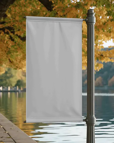 lakeside-banner-mockup-on-metal-post-with-autumn-leaves-and-reflective-water-scenery