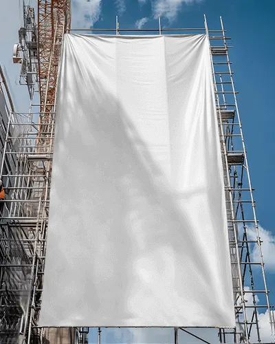 construction-scaffold-banner-mockup-hanging-on-building-site-with-blue-sky-and-shadows