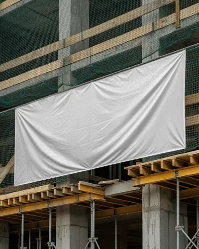 construction-site-banner-mockup-hanging-on-scaffolding-with-folds-and-netting-background