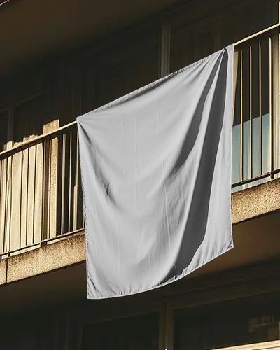 Apartment Balcony Banner Mockup Vertical Fabric Hanging Outside Building In Warm Sunset Lighting With Shadows On Walls