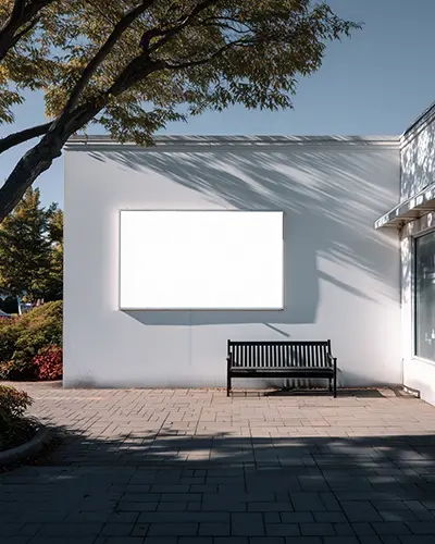 outdoor-billboard-mockup-white-wall-and-bench-under-tree-soft-shadows-peaceful-scene