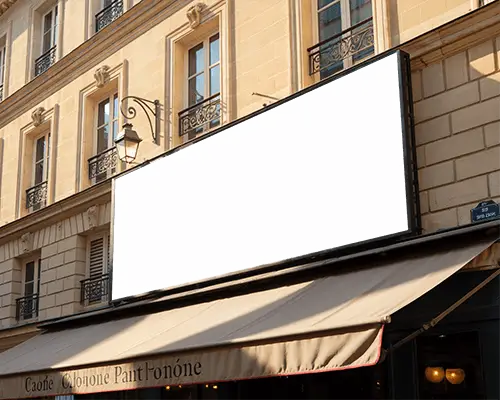 City Storefront Showing Wide Blank Billboard Mockup Ready For Promotion Insertion