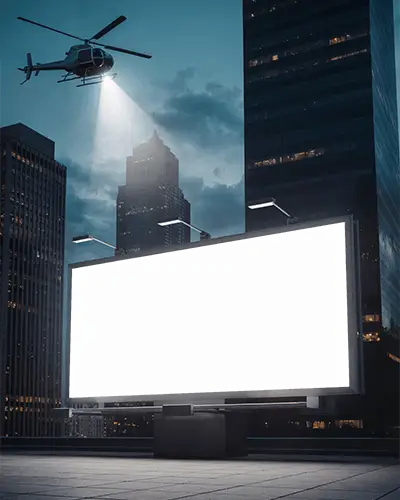 Empty Urban Billboard Mockup Lit By City Lights And Helicopter Searchlight In Nighttime Scene