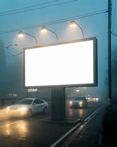 Illuminated Large Blank Billboard Mockup On Urban Road In Low Light With Moving Cars