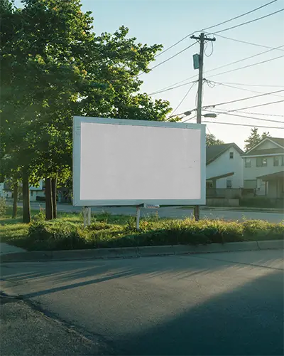Outdoor Urban Empty Billboard Mockup On Roadside Surrounded By Trees And Residential Houses