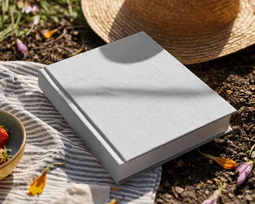 picnic-style-book-mockup-on-striped-cloth-with-sunlight-and-strawberries-in-outdoor-scene