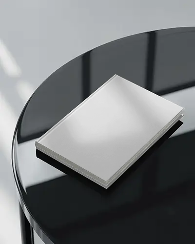 Angled Book Mockup On Glossy Black Tabletop With Soft Reflections In Modern Studio