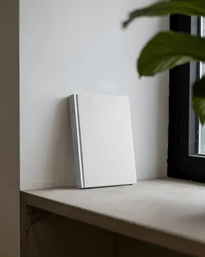 Minimalist Book Mockup Leaning Against White Wall On Window Ledge With Natural Light