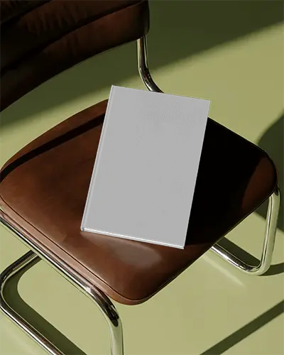 Book Mockup On Chair Mockup In Stylish Modern Setting With Sunlight Casting Long Sharp Shadows