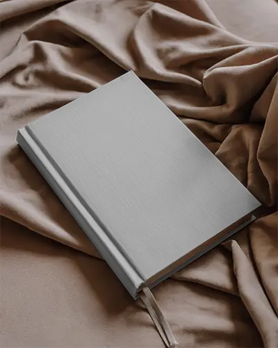 Cover Book Mockup Placed On Soft Velvet Fabric With Flowing Folds In Warm Natural Textile Background