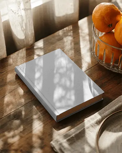 Flat Hardback Book Mockup On Rustic Wood Table In Vintage Setting With Light Patterns