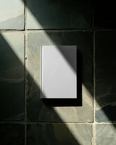 Hardcover Book Mockup On Textured Stone Tiles With Natural Sunlight Shadow Effect