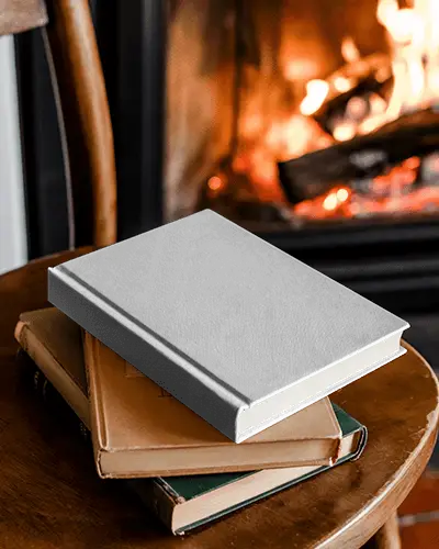 Vintage Cozy Book Mockup On Old Books With Fireplace In Background And Wooden Chair