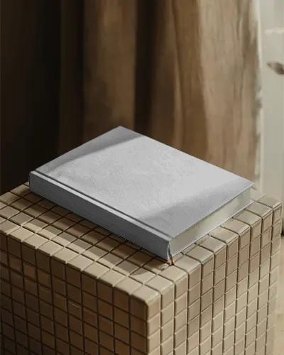 hardcover-book-mockup-on-textured-surface-with-natural-light-and-shadow-effects