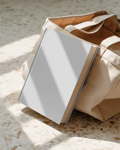 hardcover-book-mockup-with-empty-cover-in-a-sunlit-solid-background-for-branding