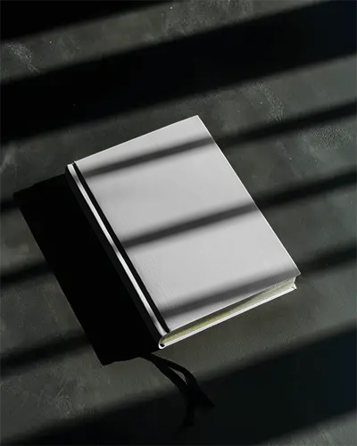 Elegant Hardcover Book Mockup On Textured Surface With Shadow Lines For Design Showcase