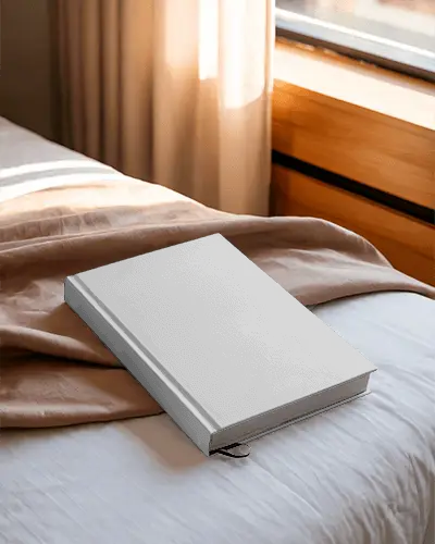 hardcover-book-mockup-placed-on-bed-natural-light-cozy-reading-scene-with-window-curtains