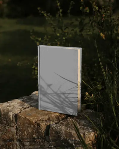 hardcover-book-mockup-with-shadow-outdoor-setting-on-rough-stone-surface-natural-light