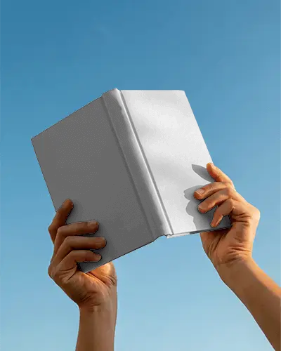 Hands Holding Hardcover Book Aloft Against Clear Sky Blank Cover Mockup