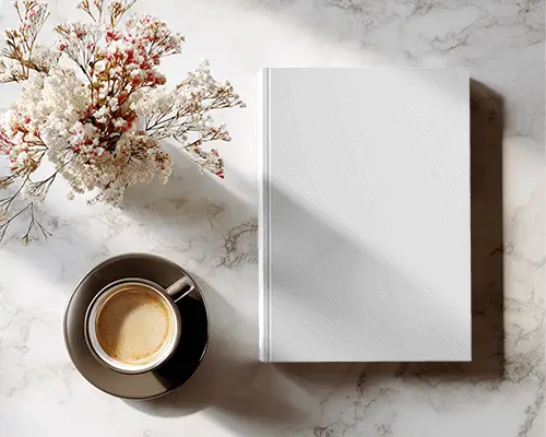 Minimalist Hardcover Book Mockup With Coffee Cup And Floral Arrangement On Marble Background