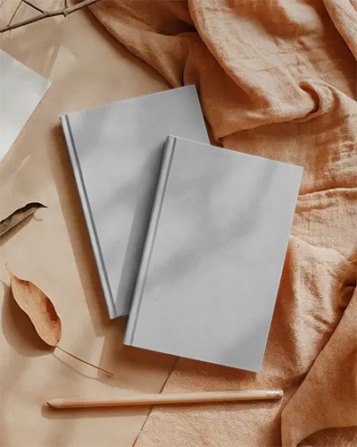 Hardcover Book Mockup On Soft Textile With Nature Inspired Stationery Arrangement