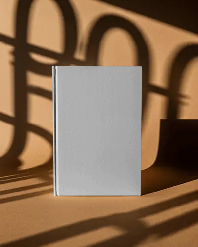 Hardcover Book Mockup On Textured Surface With Dramatic Shadow Play For Design