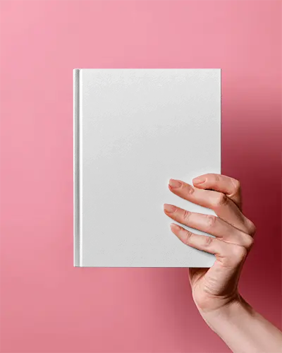 Closeup Of Hand Presenting Book Mockup On Pink Studio Backdrop