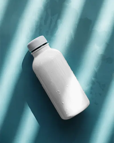Cold Beverage Bottle Mockup With Water Droplets On A Textured Background
