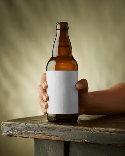 Realistic Glass Beer Bottle Mockup In Hand Showcasing Customizable Label Design