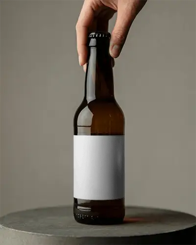 Hand Holding Beer Bottle Mockup With Blank Label For Custom Logo Design Showcase