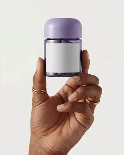 Hand Holding Small Pill Bottle Mockup For Transparent Label Medication Packaging