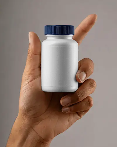 Hand Holding Small Pill Bottle Mockup For Healthcare And Pharmaceutical Packaging Design