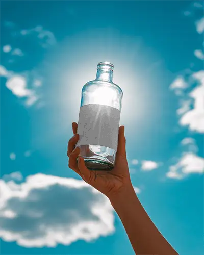 Hand Holding Glass Bottle Mockup For Drink Packaging Or Creative Product Display Presentation