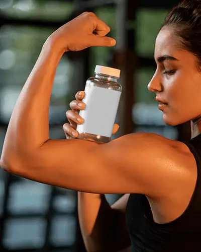Fitness Supplement Bottle Mockup Held By Athletic Woman Showing Muscle Strength