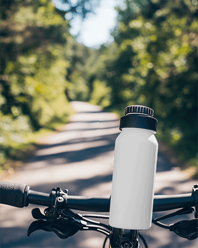 Tropical Adventure Themed Bottle Mockup With Pineapple And Coconut Design On Bicycle Handlebars In Sunny Nature Trail