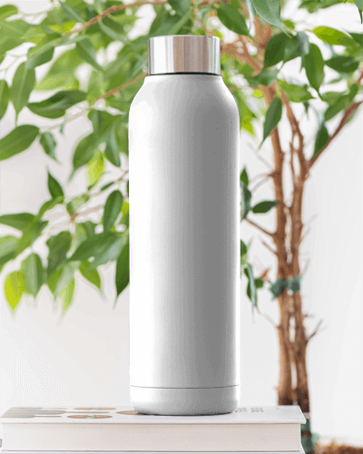 Modern White Bottle Mockup On Books With Greenery In The Background