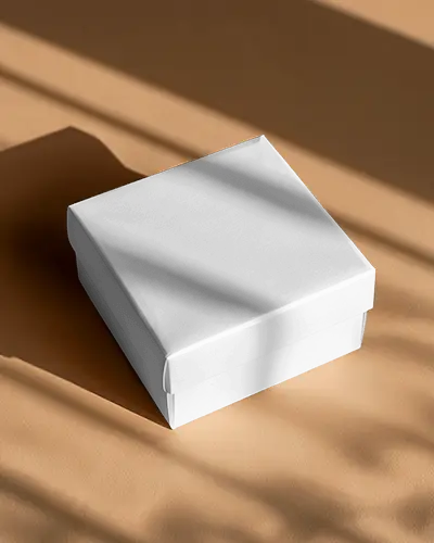 Angled Box Mockup Square Packaging On Sunlit Surface Soft Shadows Peach Background Luxury Unboxing