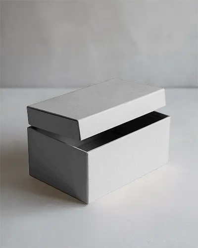 realistic-packaging-box-mockup-featuring-floating-lid-in-studio-on-white-texture