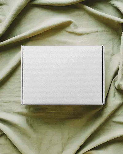 mailer-box-mockup-on-green-linen-backdrop-top-view-soft-shadow-luxury-unboxing-packaging